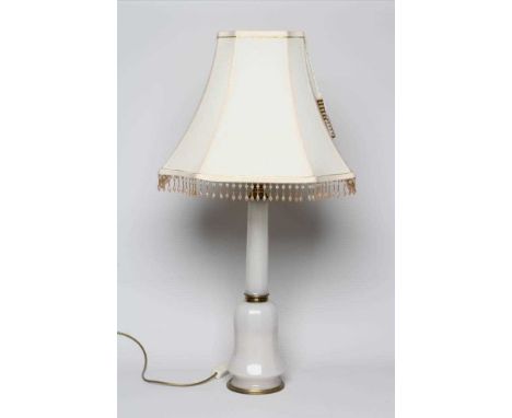 AN OPAQUE WHITE GLASS AND BRASS TABLE LAMP, mid 20th century, with faceted column and bulbous base, 35" high (including white