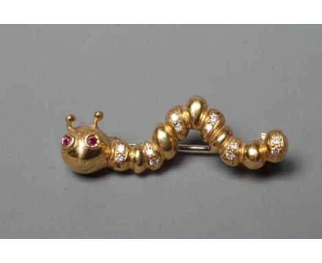 AN 18CT GOLD NOVELTY CATERPILLAR BROOCH set with two facet cut ruby eyes and with six pairs of brilliant cut diamonds to the 