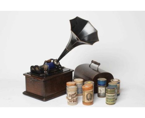 AN EDISON PHONOGRAPH, early 20th century, serial no. S3 99 711, in oak case with faceted japanned horn, 13" wide, together wi