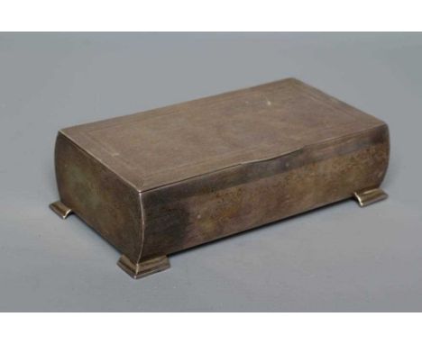 AN ART DECO SILVER CIGARETTE BOX by John Rose, Birmingham 1938, of bombe oblong form raised upon four bracket feet, the hinge