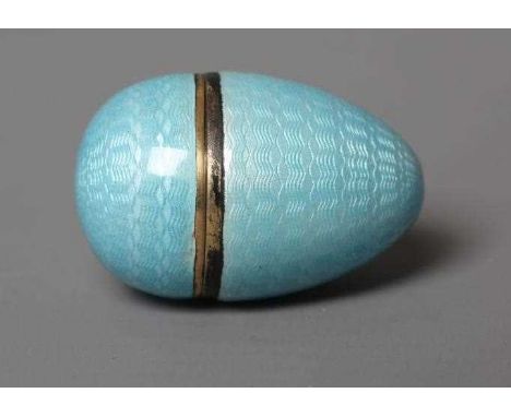 A SILVER GILT THIMBLE IN MATCHING EGG CASE, 935 standard, both with duck egg blue guilloche enamelling, thimble 1" high (Est.