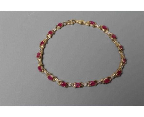 A RUBY AND DIAMOND BRACELET, the sixteen oval facet cut rubies claw set with X links between, and each centred by a small bri