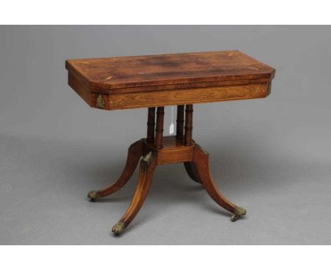 A REGENCY MAHOGANY FOLDING CARD TABLE, early 19th century, of canted oblong form with stringing and gilt metal mounts, the sw