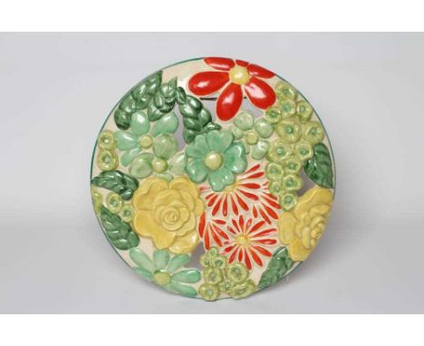 A CLARICE CLIFF WILKINSON POTTERY BIZARRE ART DECO MARGUERITE WALL MEDALLION painted in bright greens, yellow and red, printe