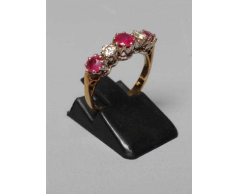 A RUBY AND DIAMOND FIVE STONE RING, the three circular facet cut rubies claw set with two brilliant cut diamonds between, eac