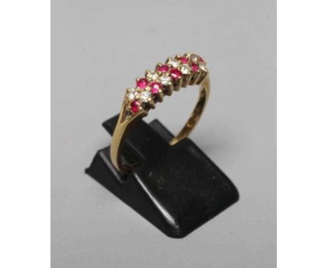 A RUBY AND DIAMOND HALF HOOP ETERNITY RING, the four pairs of claw set small brilliant cut diamonds alternating with three pa