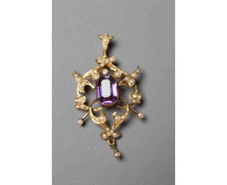 AN EDWARDIAN AMETHYST AND SEED PEARL PENDANT of typical open shield form centred by a step cut amethyst, applied 9ct plaque t
