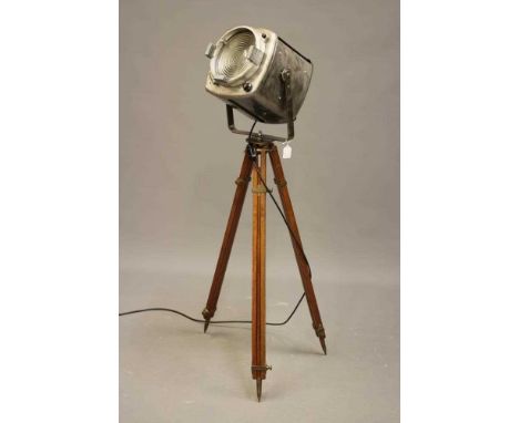 A THEATRE STAGE LAMP, stamped 1918, the wooden tripod stand with brass fittings which read: 'Stand No5 Director Mark I Adam G