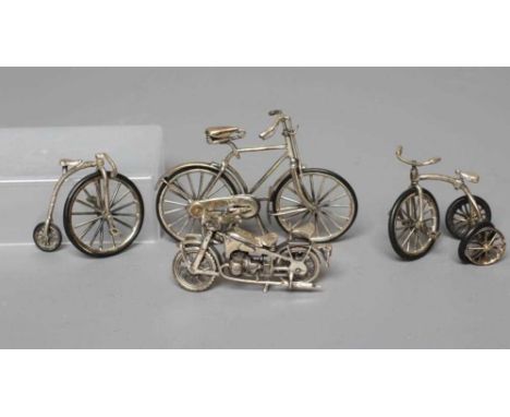 A MODERN SILVER MINIATURE MODEL PENNYFARTHING, maker's mark SMC, London import mark, stamped 925, 1 3/4" high, together with 