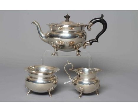 AN EDWARDIAN SILVER THREE PIECE TEA SERVICE by J Sherwood &amp; Sons, Birmingham 1909, of squat globular form with everted sh