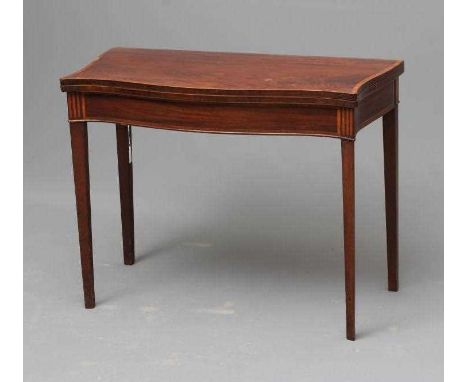 A GEORGIAN MAHOGANY FOLDING CARD TABLE, late 18th century, of serpentine oblong form crossbanded with stringing, the banded t