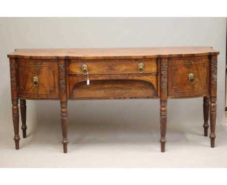 A REGENCY MAHOGANY BOWED SIDEBOARD, early 19th century, the eared top with central shallow drawer over an arched recessed dee