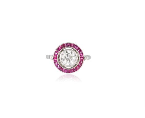 A RUBY AND DIAMOND RINGOf target design, set centrally with an old brilliant-cut diamond weighing approximately 0.90ct within