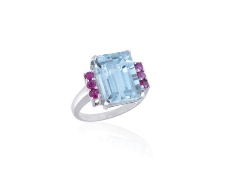 AN AQUAMARINE AND RUBY COCKTAIL RINGThe rectangular step-cut aquamarine weighing approximately 7.50cts, between a trio of cir