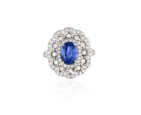 A SAPPHIRE AND DIAMOND RINGThe oval-shaped sapphire weighing approximately 1.50cts, within a millegrain pierced surround set 