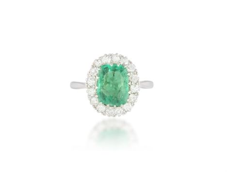 AN EMERALD AND DIAMOND CLUSTER RINGThe rectangular cushion-shaped emerald weighing 1.80cts, within a surround of old brillian