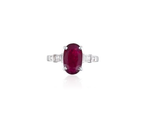 A RUBY AND DIAMOND RINGThe elongated oval-shaped ruby, weighing approximately 1.90cts, within a four claw setting and between