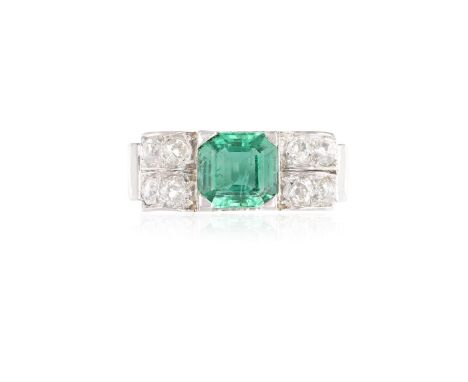 AN ART DECO EMERALD AND DIAMOND RING, CIRCA 1940The square step-cut emerald weighing approximately 1.50cts, between old brill