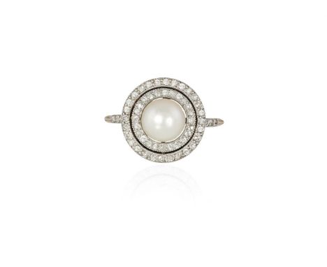 A NATURAL PEARL AND DIAMOND CLUSTER RING, CIRCA 1910The round-shaped natural pearl of cream tint, measuring approximately 7.4