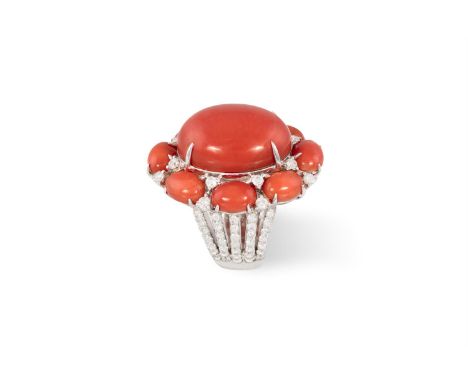 A CORAL AND DIAMOND DRESS RINGThe oval-shaped coral corallium rubrum cabochon, within a frame of similarly-cut coral and roun