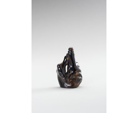 A BLACK CORAL SNUFF BOTTLEChina, late Qing Dynasty (1644-1912). The fine bottle conforming to the natural outline of a coral 