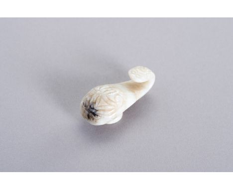A MINIATURE JADE 'DRAGON' BELT HOOKChina, early Qing Dynasty (1644-1912). The top is carved with a flower and the hook with a
