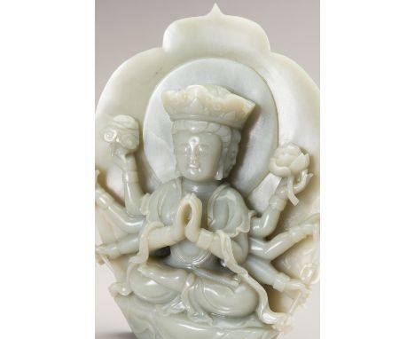 A CELADON JADE FIGURE OF AVALOKITESHVARAChina, 20th century. The three-headed and eight-armed deity carved seated in dhyanasa