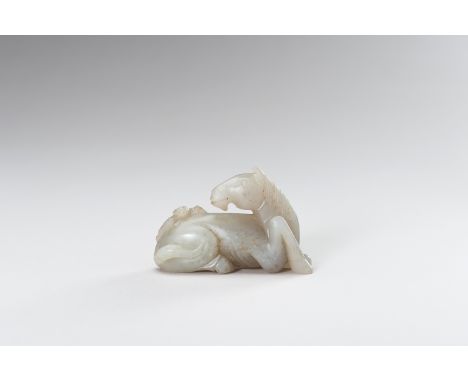 A CELADON JADE HORSE WITH BATChina, late Qing (1644-1912). Carved as a recumbent horse, the head tilted back towards the bat 