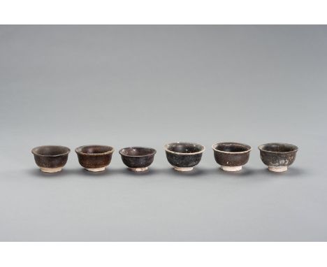 SIX FOOTED 'SHIPWRECK' CERAMIC CUPSSouthern China, 12th-14th century. Comprising six brown glazed small cups.Condition: With 