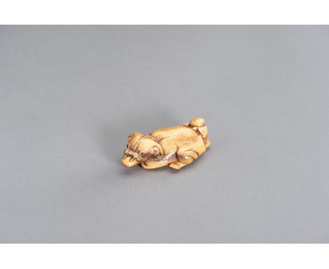 A STAG ANTLER NETSUKE OF AN OX AND OXHERDJapan, 18th century, Edo period (1615-1868)Depicting a recumbent ox with inlaid eyes