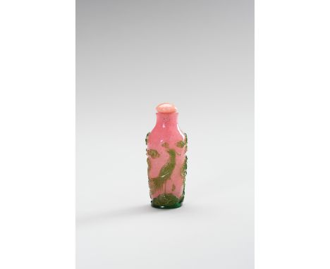 A GREEN AND PINK OVERLAY GLASS SNUFF BOTTLEChina, Qing Dynasty (1644-1912). The tapering elongated ovoid body rising from a t