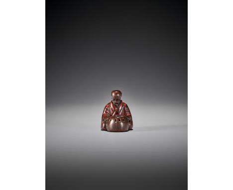 AN EARLY LACQUERED WOOD NETSUKE OF A MAN WITH HIBACHIUnsignedJapan, 18th century, Edo period (1615-1868)Depicting a man, prob