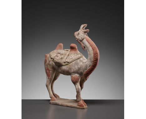 A PAINTED POTTERY FIGURE OF A BACTRIAN CAMEL, TANG DYNASTYChina, 618-907. Standing foursquare atop the shaped base, the bayin