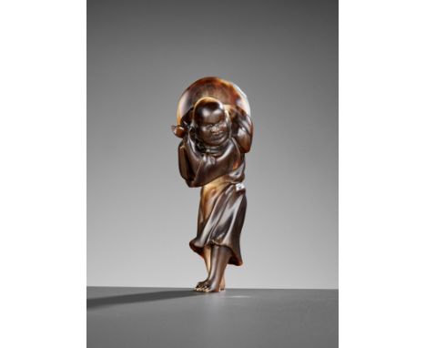 A RARE AND LARGE HORN NETSUKE OF A FOREIGNERUnsignedJapan, 19th century, Edo period (1615-1868)Finely carved from a large sec