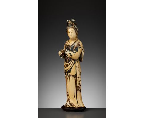 A PAINTED IVORY FIGURE OF A LADY, QING DYNASTYChina, 1644-1912. Wearing voluminous robes, decorated in gilt with a key-fret p