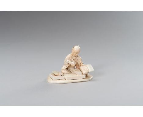 AN IVORY OKIMONO OF A CALLIGRAPHY ARTISTJapan, Meiji period (1868-1912). The segmented okimono carved as a seated calligraphy