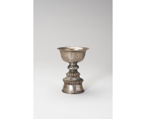 A CHASED SILVERED COPPER BUTTER LAMPTibet, 19th century. The fine deep stem bowl incised with the eight Buddhist treasures, r