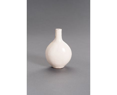 A MOLDED AND CREAM-GLAZED CERAMIC FLASK, MING DYNASTYChina, 1368-1644. The flattened globular body rising from a short oval f