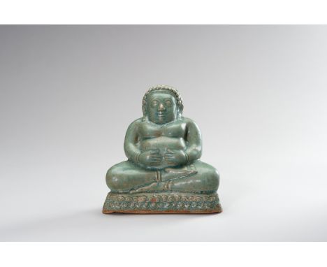 A CELADON-GLAZED FIGURE OF BUDAISouth China/ Northern Vietnam, c. 1900. Seated in dhyanasana on a two-tiered base, the hands 