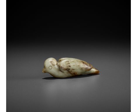 A CELADON JADE FIGURE OF A BIRD, SONG DYNASTYChina, 960-1279. The recumbent bird with long tail, incised eyes, wings, and fea