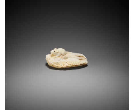 A RARE MARINE IVORY NETSUKE OF A RAT ON LEAFY DAIKONJapan, early 19th century, Edo period (1615-1868)The rat with inlaid eyes