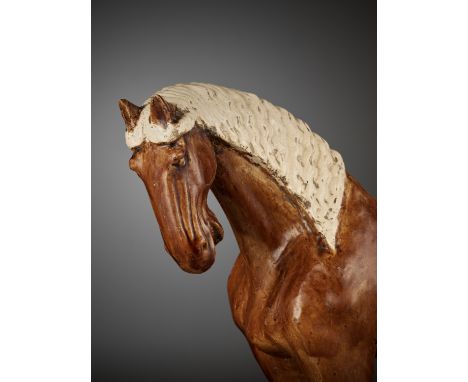 AN AMBER-GLAZED POTTERY HORSE WITH WHITE-GLAZED BRAIDED MANE AND TAILChina, Tang Dynasty Style, but dating to the late Qing D