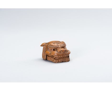 A WOOD MASK NETSUKE OF A SHISHI HEADJapan, 20th centuryThe pale wood netsuke mask of a shishi head with a movable jaw, the mo