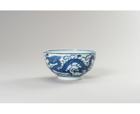 A BLUE AND WHITE PORCELAIN 'DRAGON' BOWLChina, Qing Dynasty (1644-1912). The deep rounded sides rising from a short ring foot