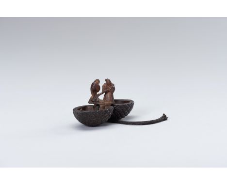 A WOOD KARAKURI NETSUKE OF JO AND UBA INSIDE A PINECONE, ATTRIBUTED TO KAGETOSHIAttributed to Kagetoshi, unsigned Japan, Edo 