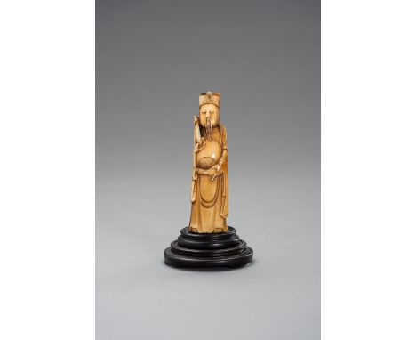 AN IVORY CARVING OF AN IMMORTAL, MINGChina, Ming dynasty (1368-1644). Carved as an immortal with a long beard holding a ruyi-