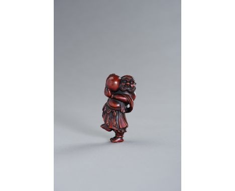 A LARGE RESIN NETSUKE OF AN ISLANDERThe large netsuke depicting a strong islander standing on one foot hefting a large pearl.