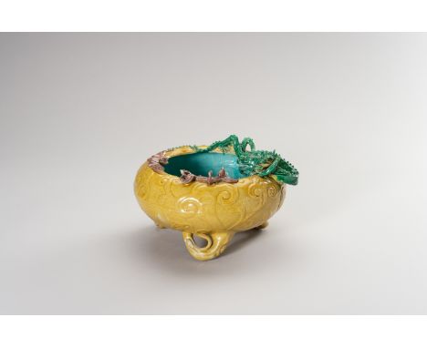A GLAZED PORCELAIN BASIN WITH DRAGON AND BATChina, Republic period (1912-1949). Heavily potted, the compressed rounded body m