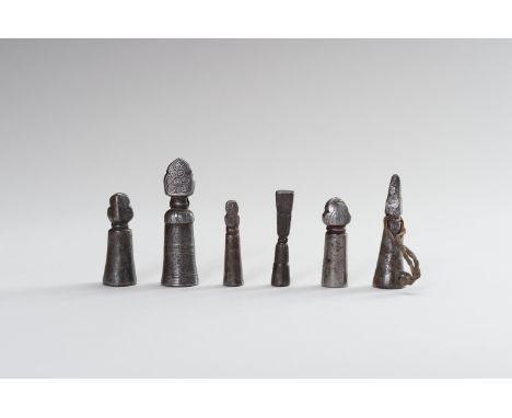 A FINE GROUP OF SIX CAST IRON SEALSTibet, 19th century. Five of cylindrical tapering shape surmounted by a stupa finial, one 