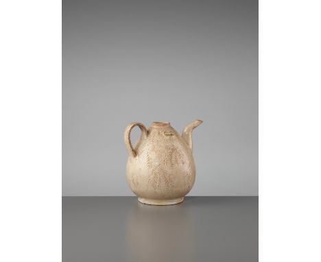 A STRAW-GLAZED AND INCISED 'TEA LEAVES' EWER, SONG DYNASTYChina, 960-1279. The pear-shaped body rising from a short straight 